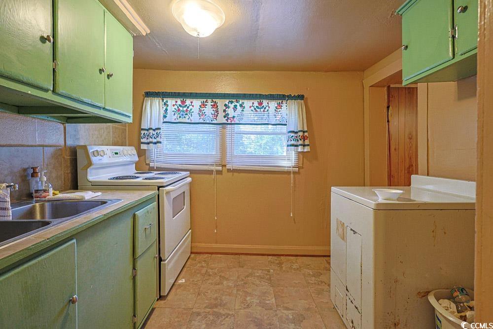 8444 Franklin Drive Conway, SC 29527 - Photo 13 of 34 Kitchen featuring green cabinetry, white range with electric stovetop, washer / clothes dryer, and light countertops