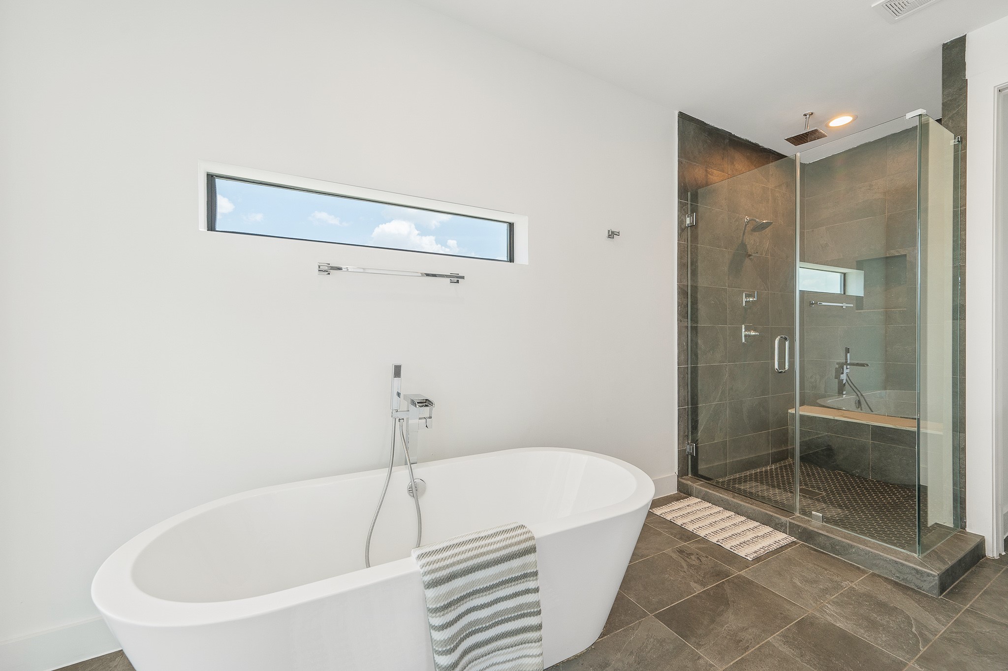 2239 North MacGregor Way Houston, TX 77004 - Photo 17 of 39 a white bath tub sitting next to a bathroom