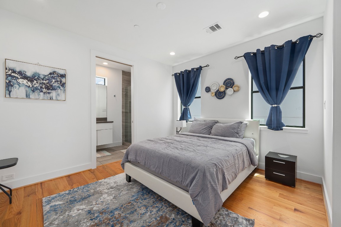 2239 North MacGregor Way Houston, TX 77004 - Photo 23 of 39 a bedroom with a bed and a painting on the wall