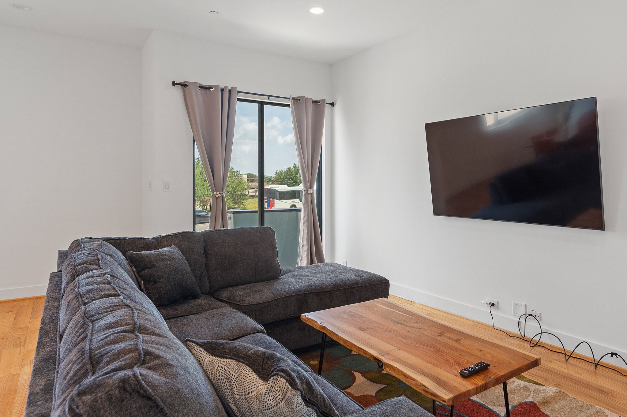 2239 North MacGregor Way Houston, TX 77004 - Photo 35 of 39 a living room with furniture and a flat screen tv