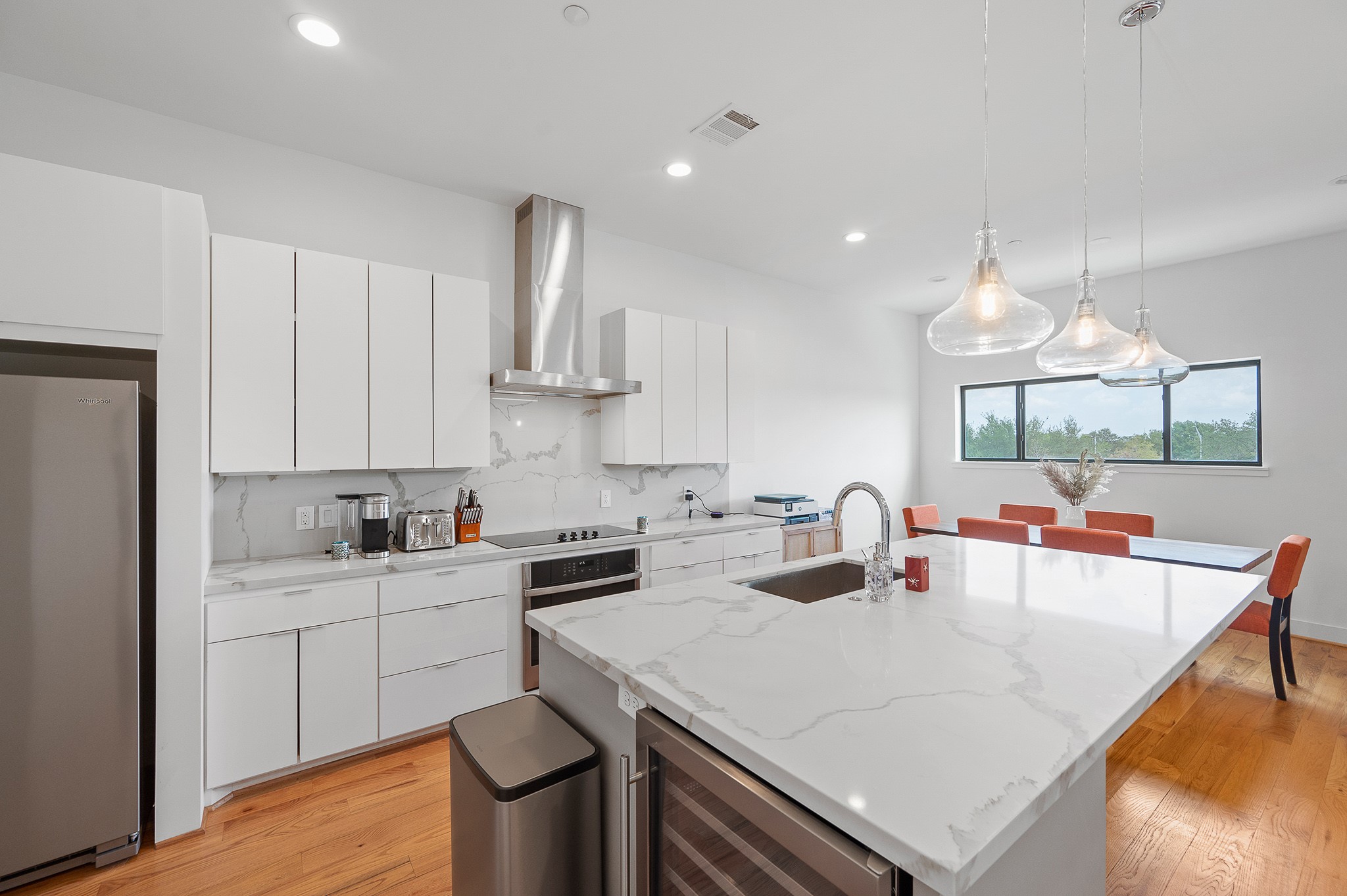 2239 North MacGregor Way Houston, TX 77004 - Photo 10 of 39 a kitchen with a sink a stove and chairs