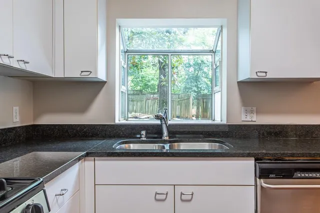 a kitchen with granite countertop a stove and a refrigerator