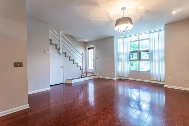 a view of a hallway with a window and a livingroom
