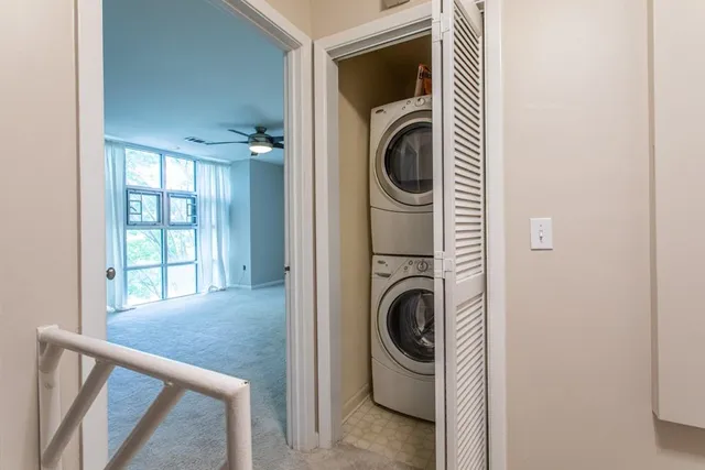 a bedroom with a bed a mirror and a large window