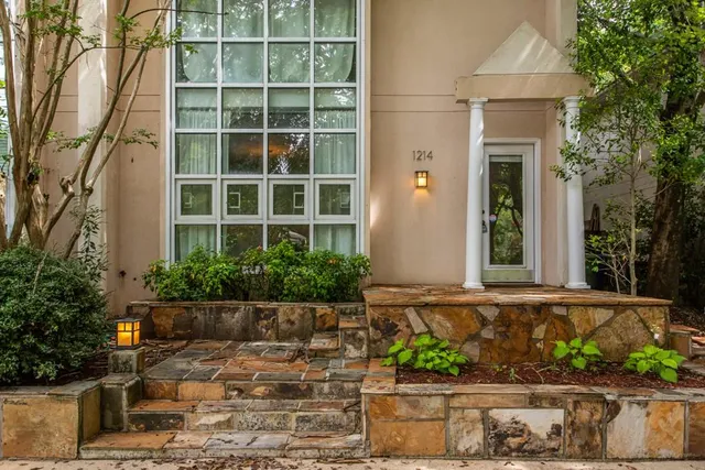 a front view of a house with a garden
