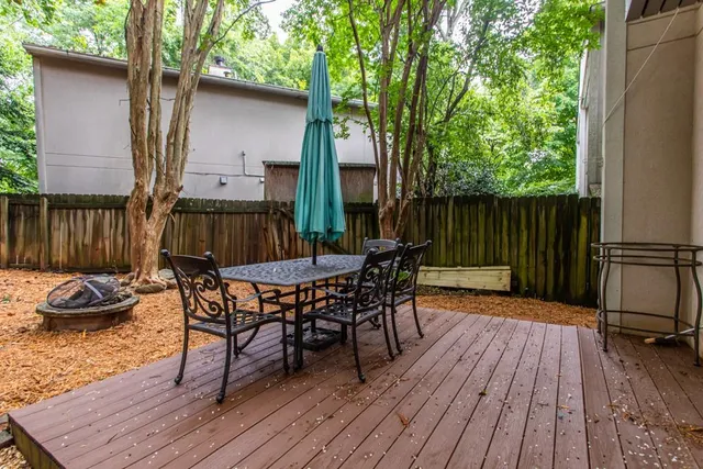 a view of a patio with couches table and chairs and potted plants
