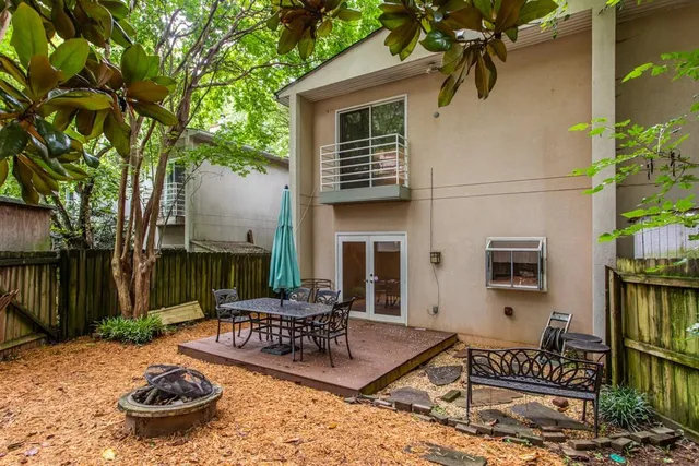 a backyard of a house with lake view and wooden fence