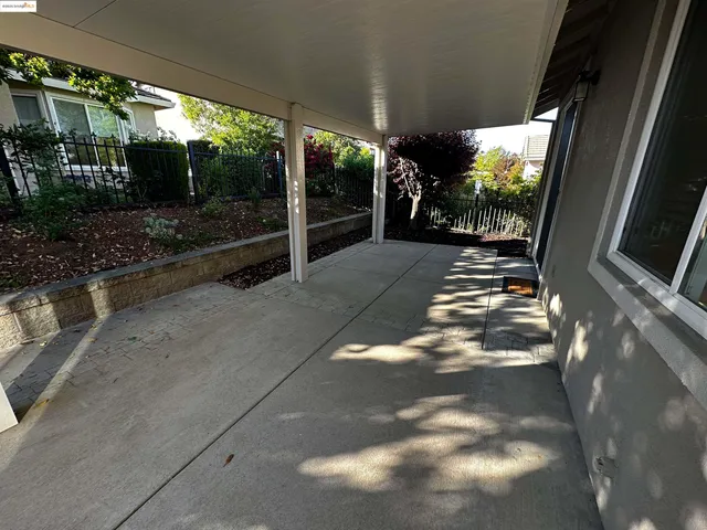 a view of a balcony with flower plants
