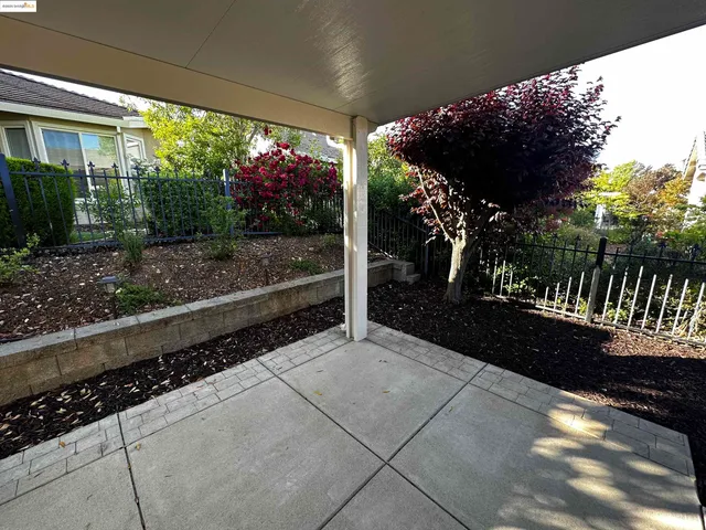a view of a patio with table and chairs potted plants with wooden floor
