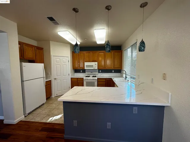 a kitchen with kitchen island a sink appliances and cabinets