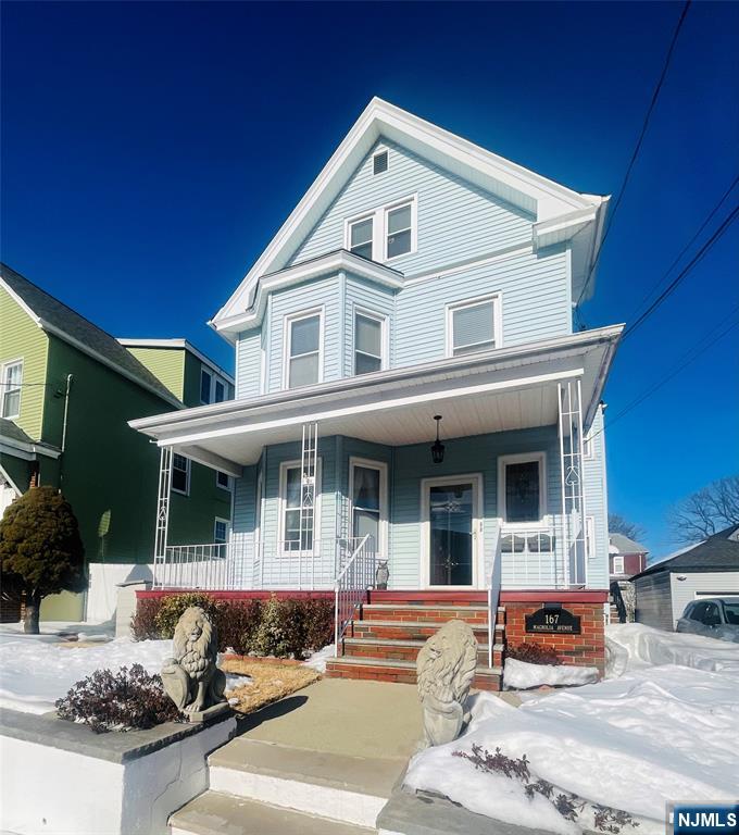 a front view of a house with outdoor seating and a window