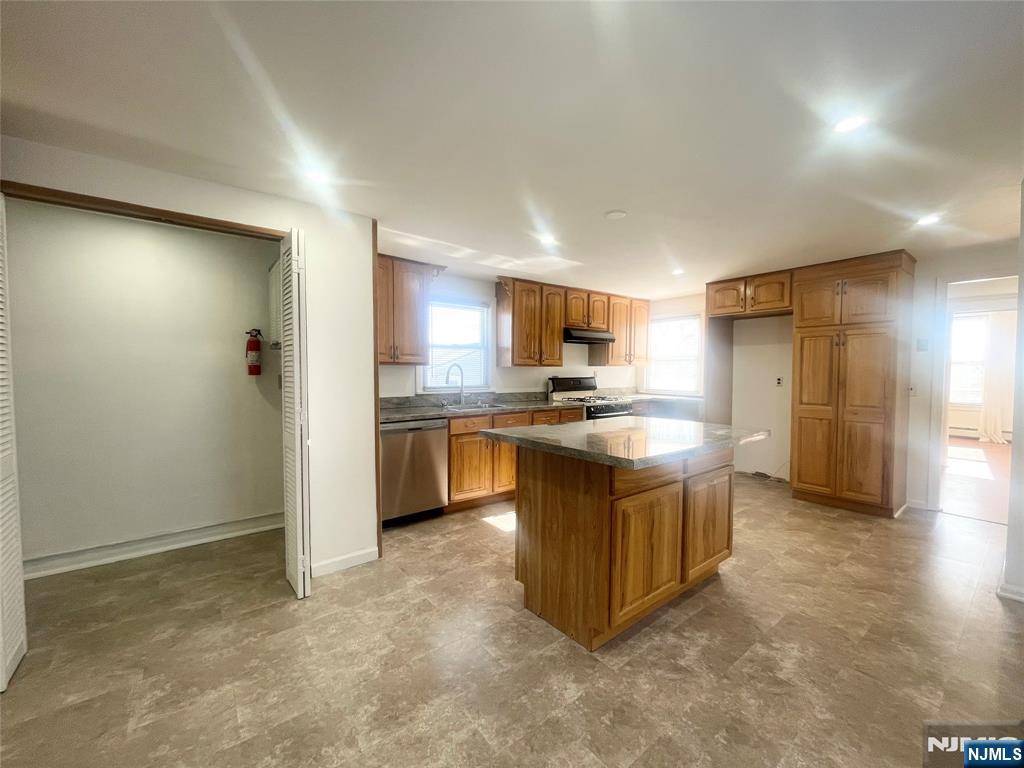 169 Magnolia Avenue, Unit 2 3 Kearny, NJ 07032 - Photo 13 of 23 a kitchen with cabinets and stainless steel appliances