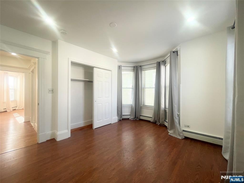 169 Magnolia Avenue, Unit 2 3 Kearny, NJ 07032 - Photo 15 of 23 an empty room with wooden floor and windows