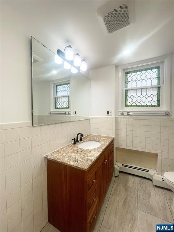 169 Magnolia Avenue, Unit 2 3 Kearny, NJ 07032 - Photo 17 of 23 a bathroom with a sink a vanity and a mirror