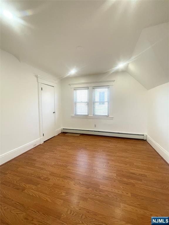 169 Magnolia Avenue, Unit 2 3 Kearny, NJ 07032 - Photo 20 of 23 an empty room with wooden floor and windows