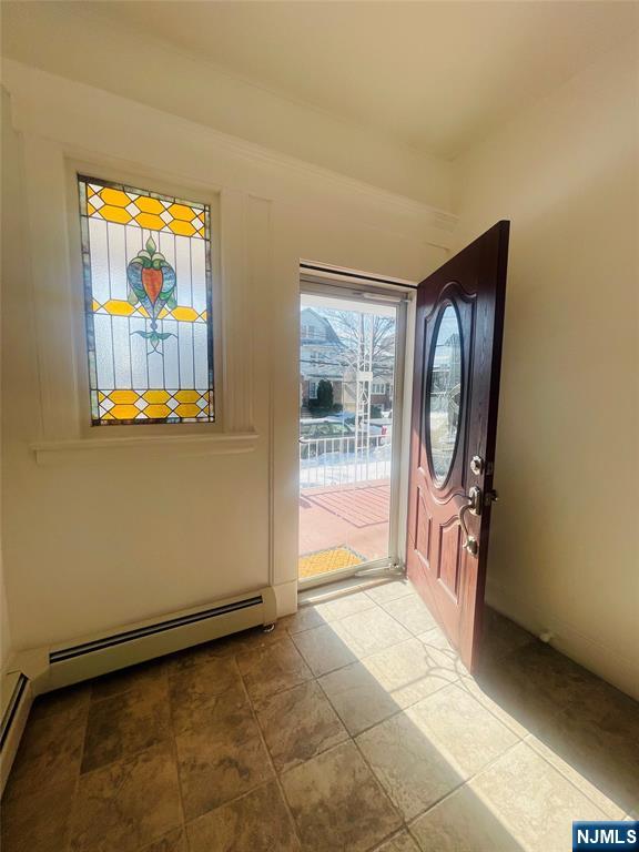 169 Magnolia Avenue, Unit 2 3 Kearny, NJ 07032 - Photo 3 of 23 a view of a livingroom with wooden floor and windows