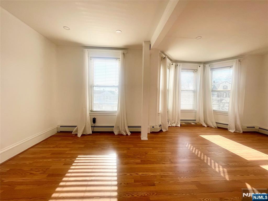 169 Magnolia Avenue, Unit 2 3 Kearny, NJ 07032 - Photo 8 of 23 a view of a room with wooden floor and windows