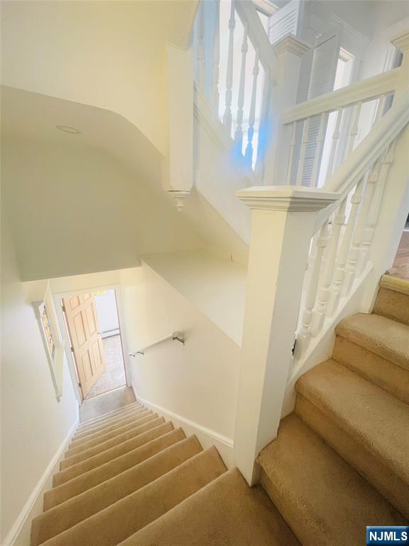 169 Magnolia Avenue, Unit 2 3 Kearny, NJ 07032 - Photo 9 of 23 a bedroom with a bed and a chandelier