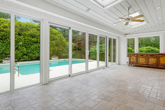 a view of an empty room with a fireplace and a large window