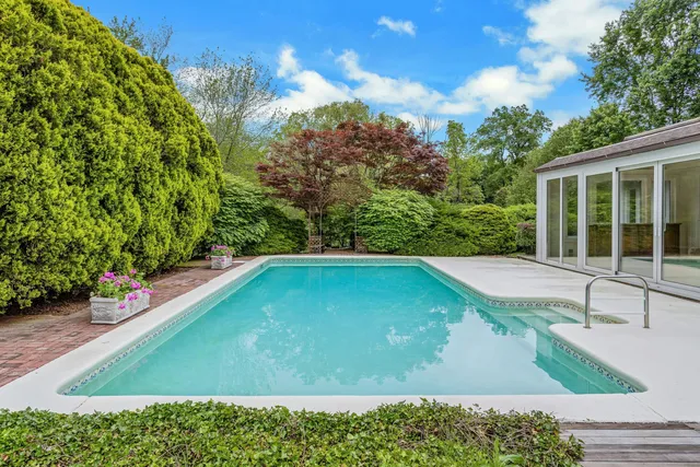 a view of a swimming pool with an outdoor seating area