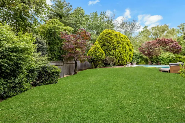 a view of a golf course with a house in the background
