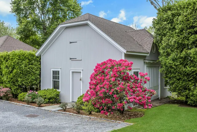 a front view of house with flowers