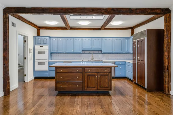 a kitchen with stainless steel appliances granite countertop a refrigerator and a stove top oven