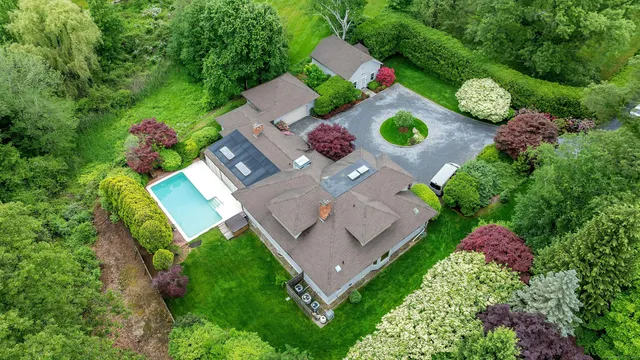 an aerial view of a house with yard