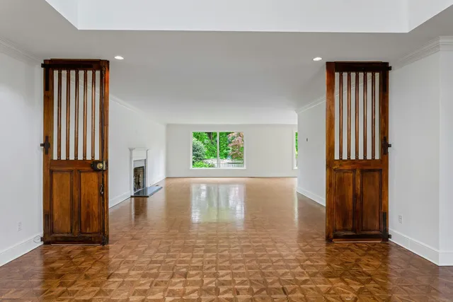 an empty room with windows and closet