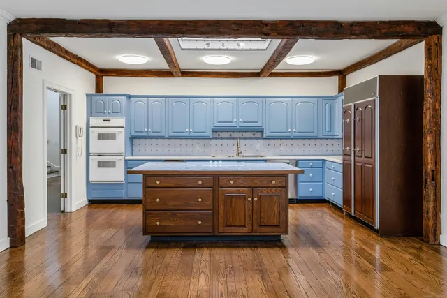 a kitchen with stainless steel appliances granite countertop a refrigerator and a stove top oven