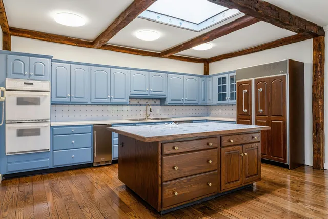 a kitchen with stainless steel appliances granite countertop a stove and a refrigerator