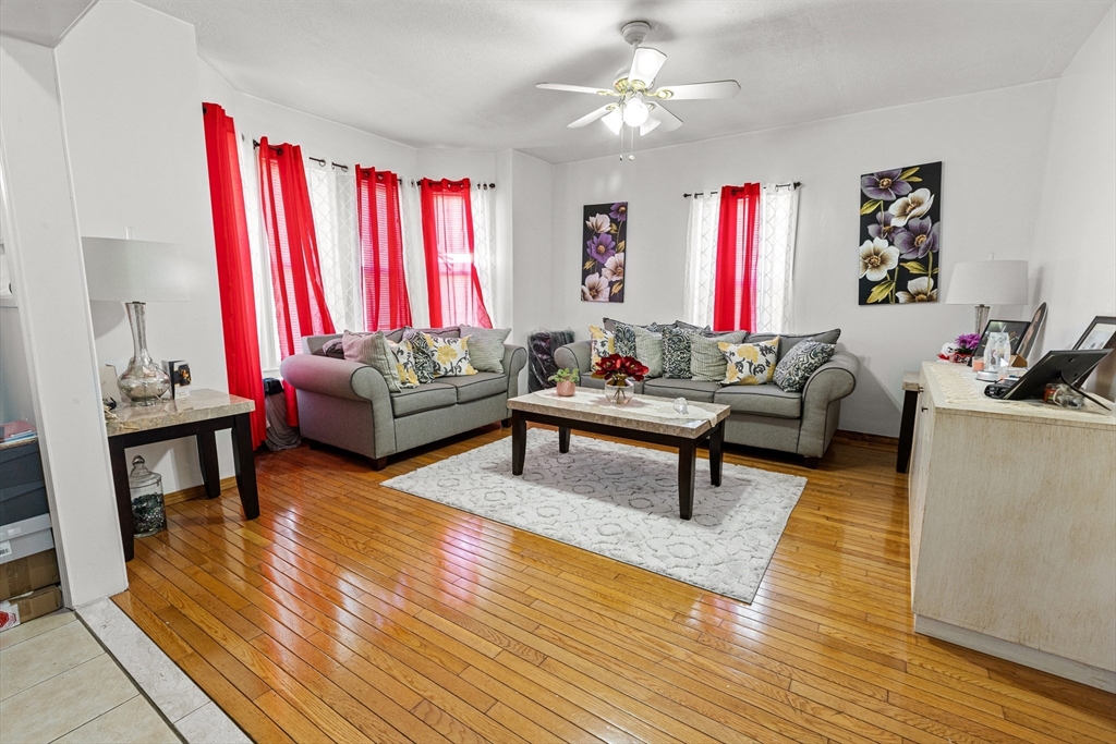 62-66 Butler Street Lawrence, MA 01841 - Photo 14 of 37 a living room with furniture a fireplace and a window