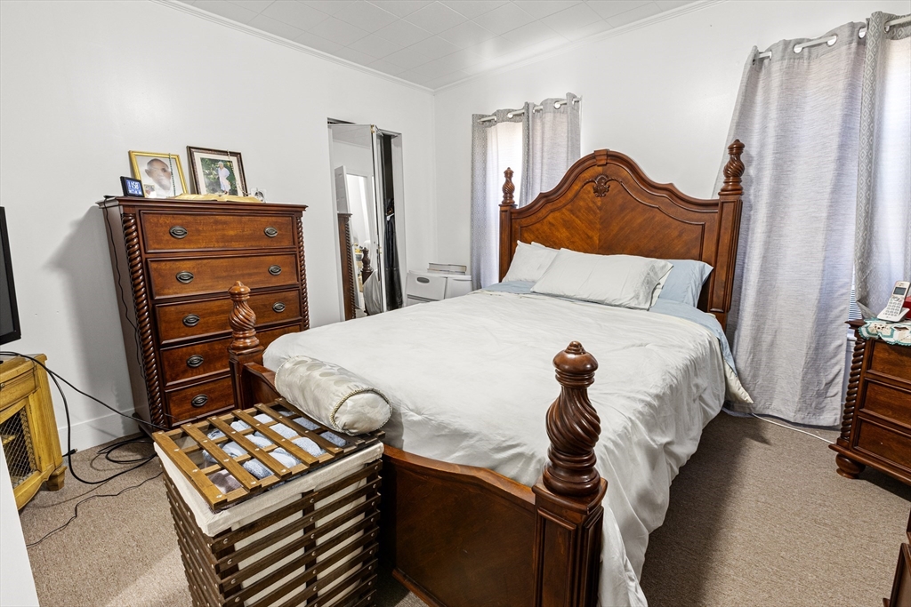 62-66 Butler Street Lawrence, MA 01841 - Photo 19 of 37 a bedroom with a bed and a dresser