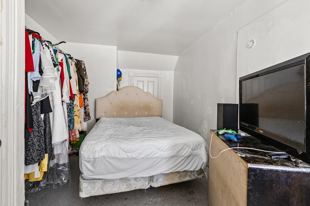 62-66 Butler Street Lawrence, MA 01841 - Photo 20 of 37 a bedroom with a bed and a flat screen tv