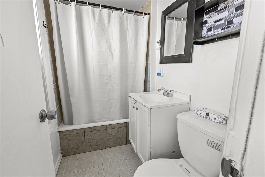 62-66 Butler Street Lawrence, MA 01841 - Photo 22 of 37 a bathroom with a sink toilet and shower
