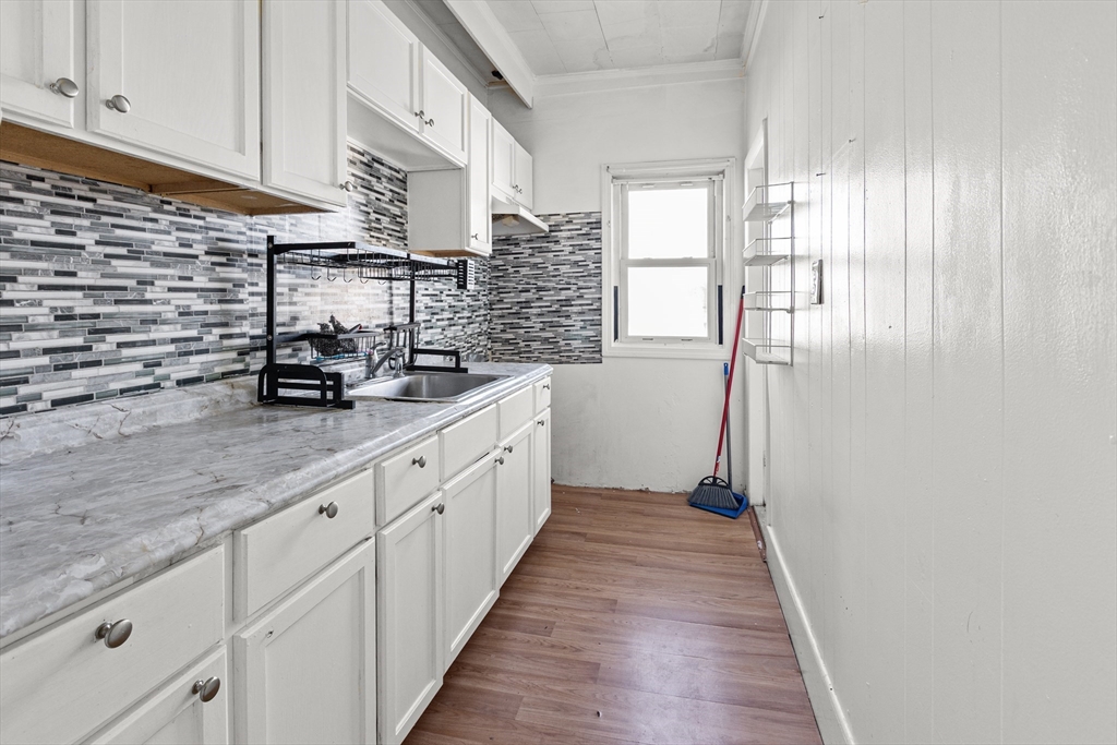 62-66 Butler Street Lawrence, MA 01841 - Photo 24 of 37 a kitchen with stainless steel appliances a sink stove and cabinets
