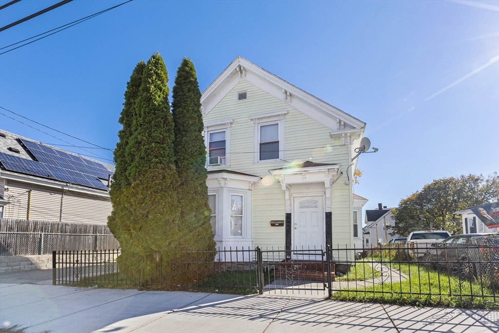 62-66 Butler Street Lawrence, MA 01841 - Photo 3 of 37 a front view of a house with a yard
