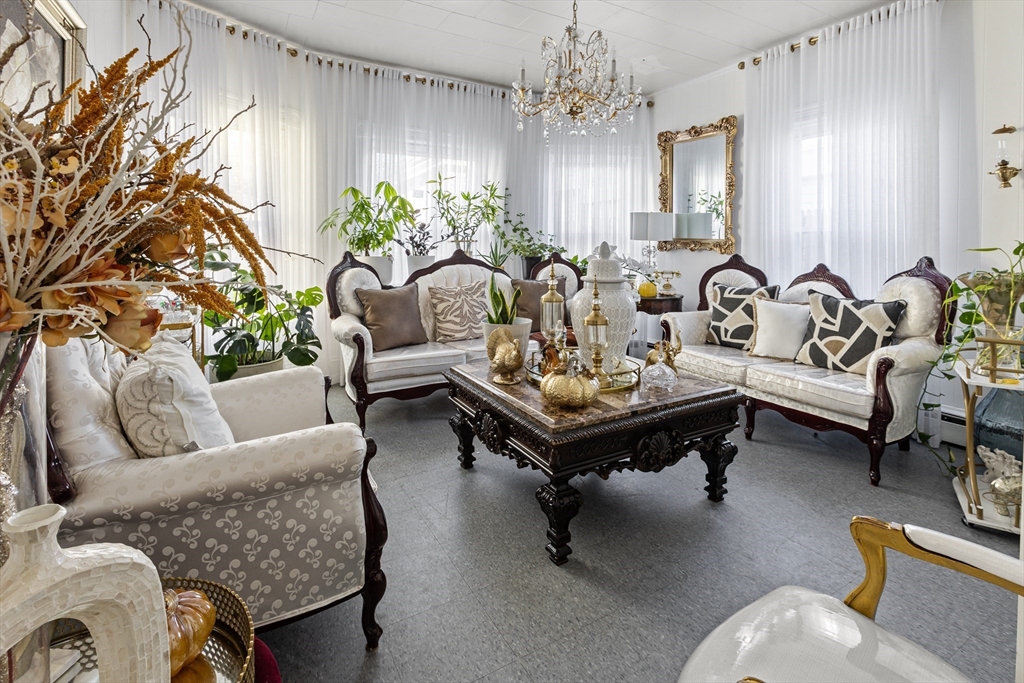 62-66 Butler Street Lawrence, MA 01841 - Photo 32 of 37 a living room with furniture and a chandelier
