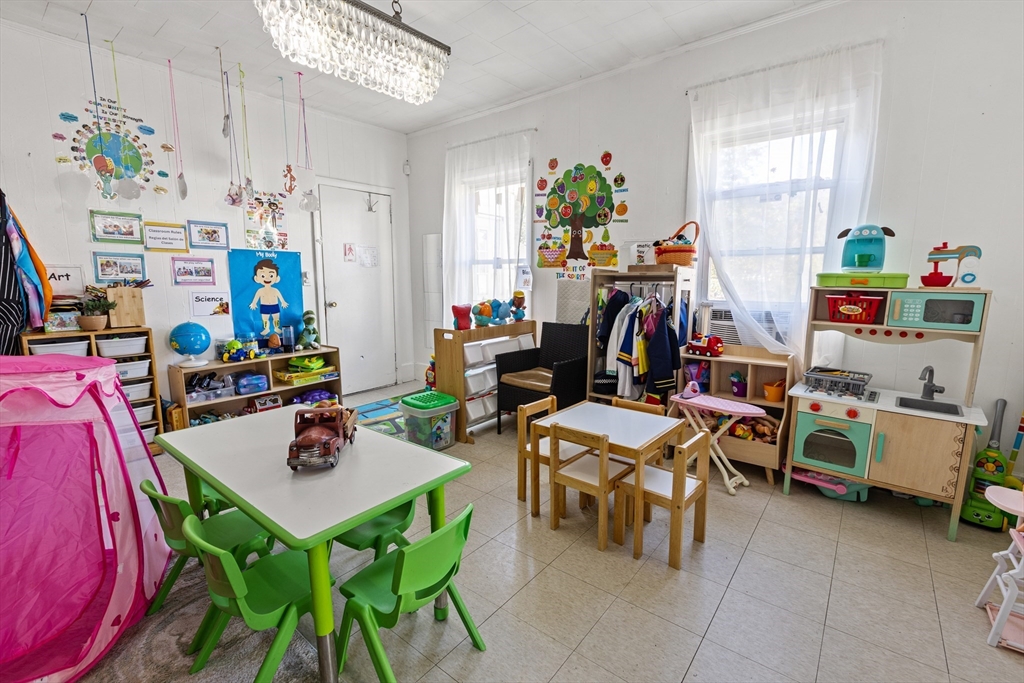 62-66 Butler Street Lawrence, MA 01841 - Photo 33 of 37 a room with furniture a rug toys and a chandelier
