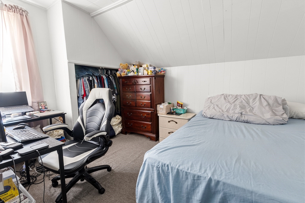 62-66 Butler Street Lawrence, MA 01841 - Photo 34 of 37 a bedroom with a bed and a desk