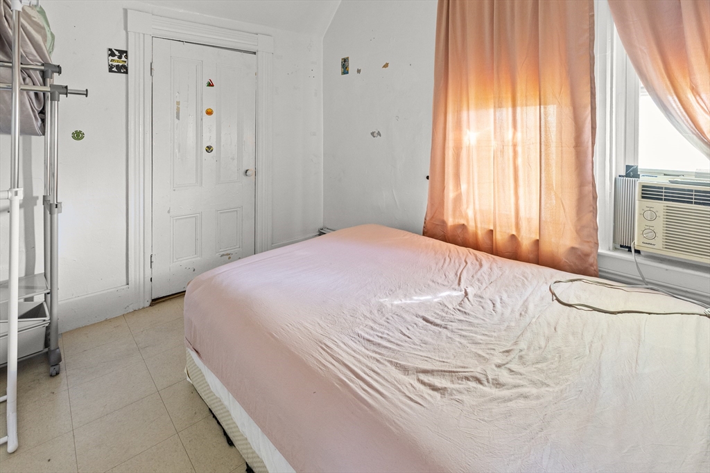 62-66 Butler Street Lawrence, MA 01841 - Photo 36 of 37 a bedroom with a bed and a window