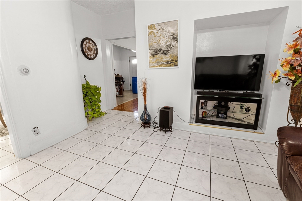 62-66 Butler Street Lawrence, MA 01841 - Photo 5 of 37 a view of a livingroom with furniture and a flat screen tv