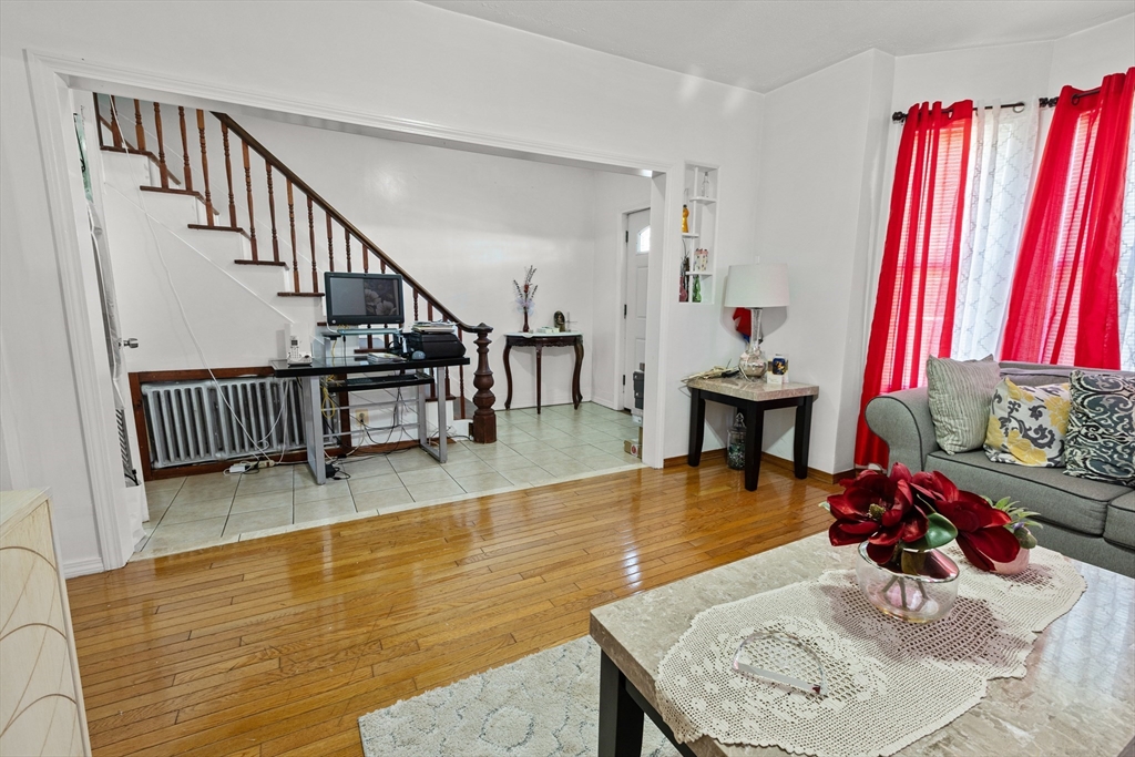 62-66 Butler Street Lawrence, MA 01841 - Photo 7 of 37 a living room with furniture and a wooden floor