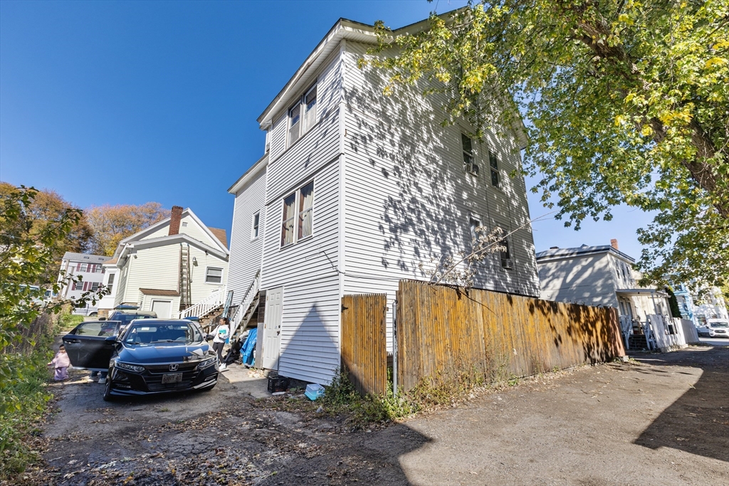 62-66 Butler Street Lawrence, MA 01841 - Photo 9 of 37 a car parked in front of a house