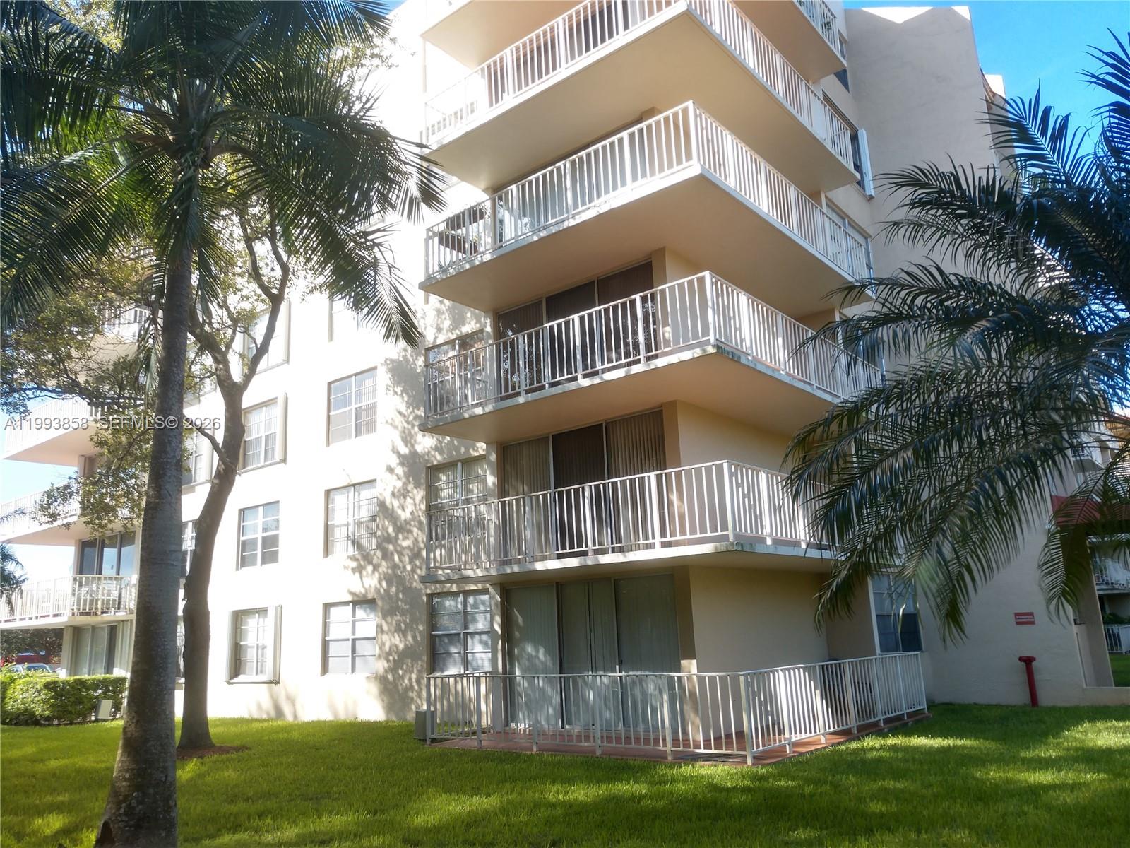 13100 Southwest 92nd Avenue, Unit A112 Miami, FL 33176 - Photo 1 of 6 a front view of a house with a yard
