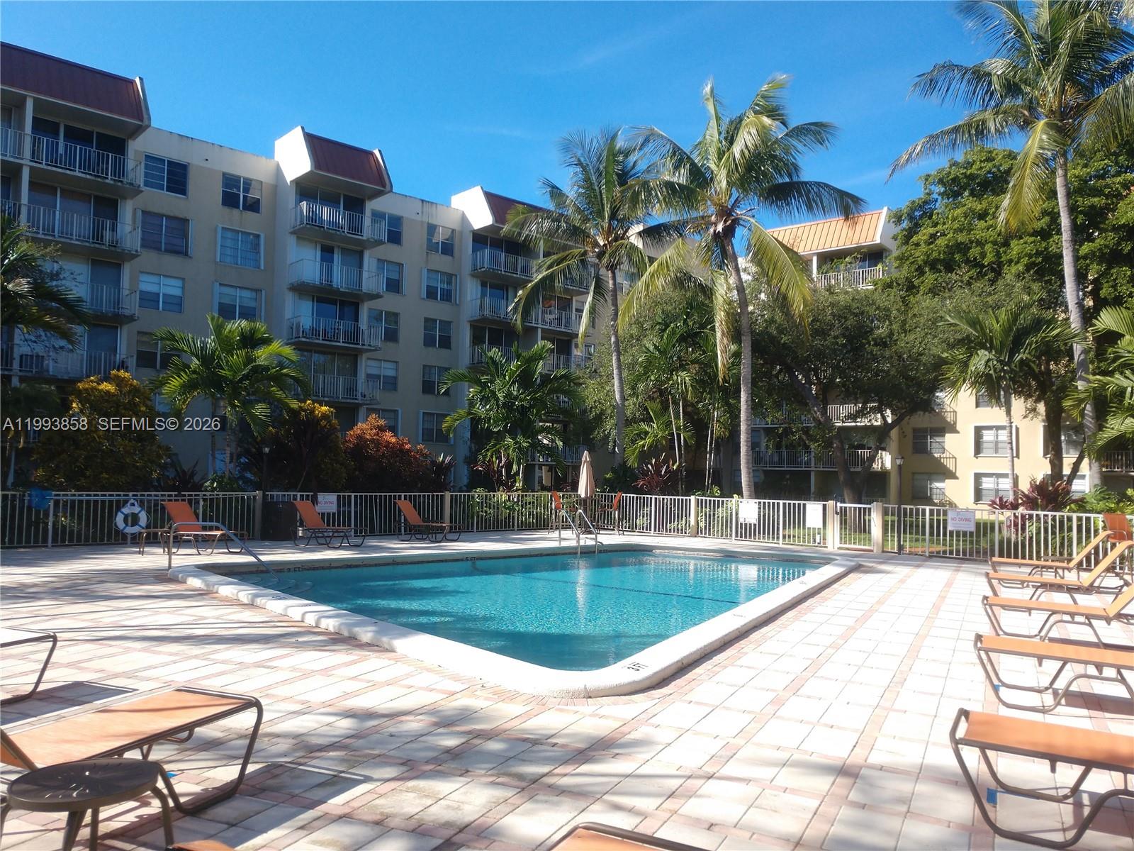 13100 Southwest 92nd Avenue, Unit A112 Miami, FL 33176 - Photo 3 of 6 a view of a swimming pool with a patio