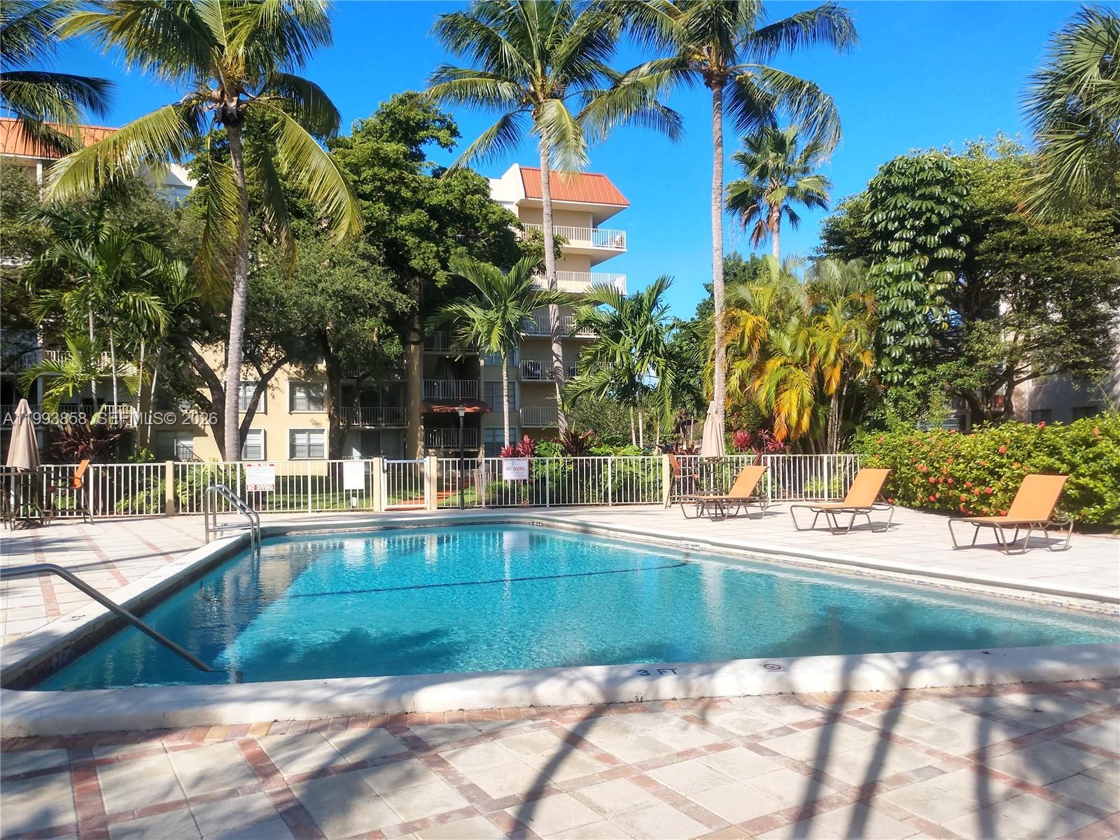 13100 Southwest 92nd Avenue, Unit A112 Miami, FL 33176 - Photo 4 of 6 a view of swimming pool with outdoor seating and plants