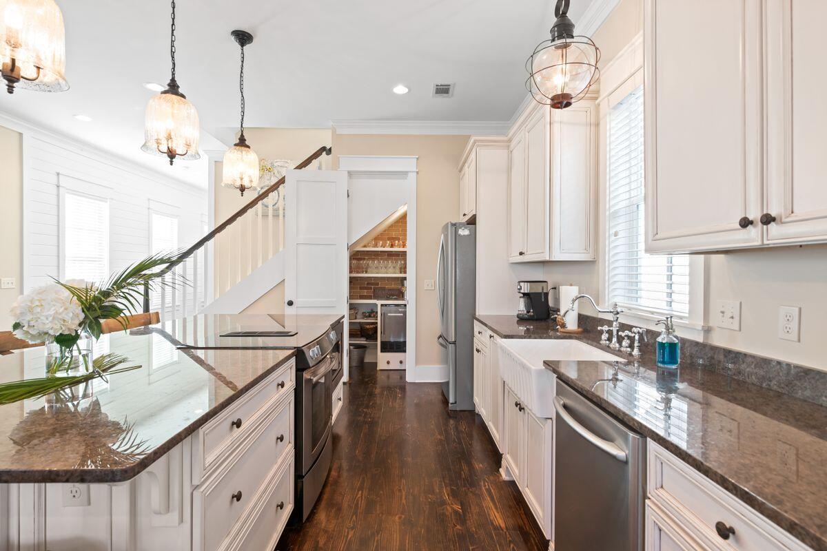 113 Lifeguard Loop West Inlet Beach, FL 32461 - Photo 12 of 51 a kitchen with stainless steel appliances granite countertop a sink a stove and chairs with wooden floor