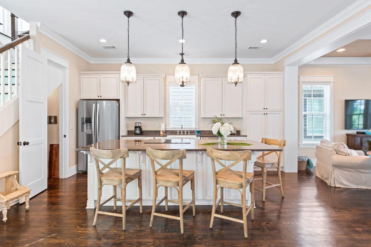 113 Lifeguard Loop West Inlet Beach, FL 32461 - Photo 10 of 51 a kitchen with stainless steel appliances kitchen island granite countertop a dining table chairs and white cabinets