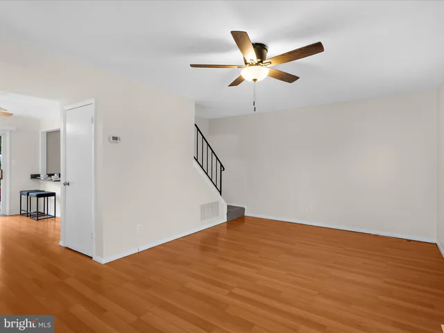 a view of an empty room with wooden floor